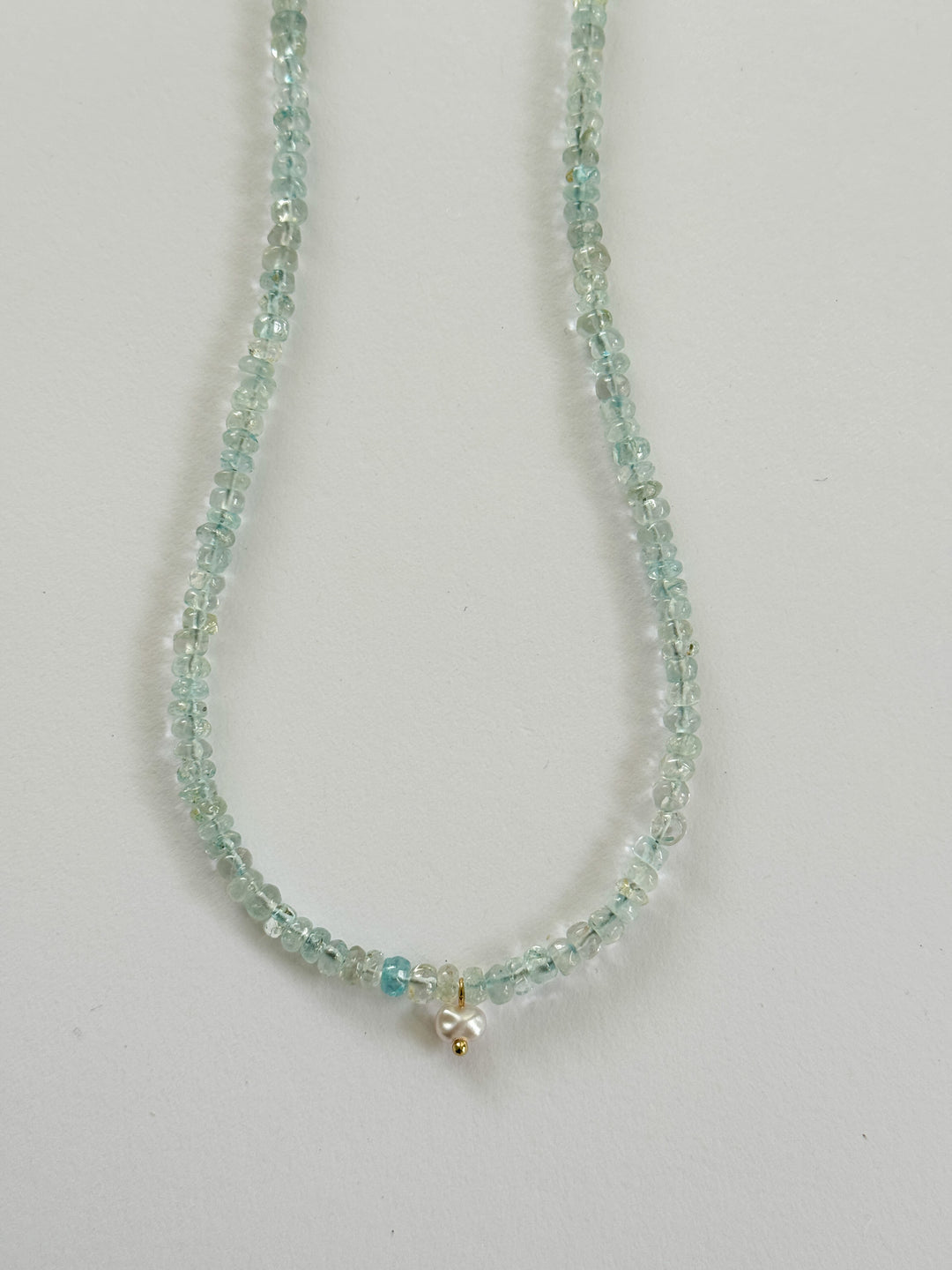 Necklace with small aquamarine beads with a small pearl charm
