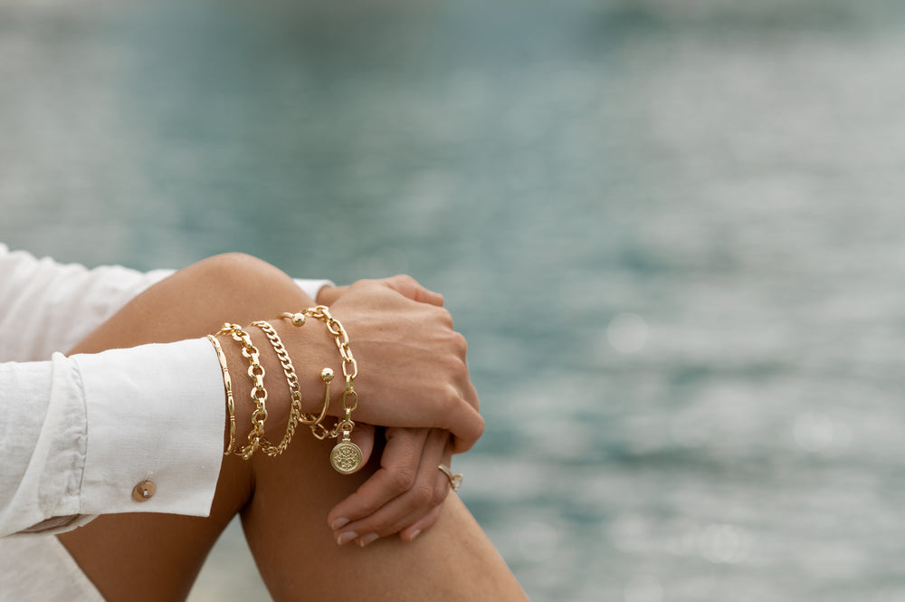 Woman’s arm with gold braceletes